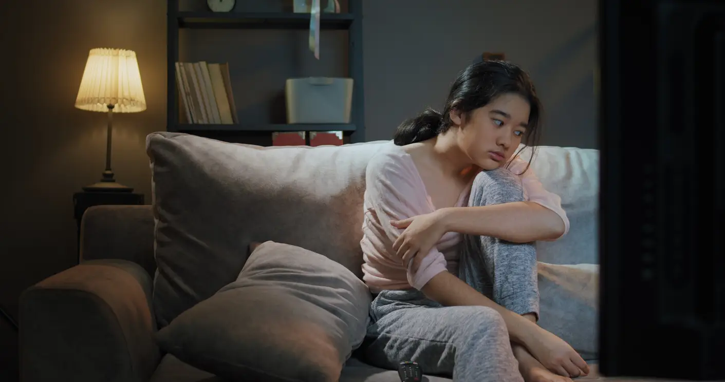 girl sitting on sofa bored