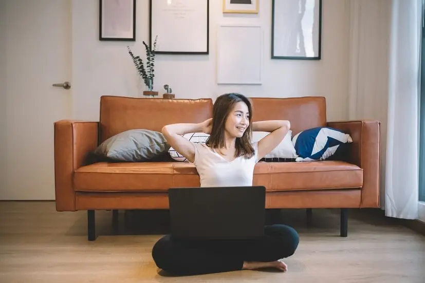 Woman on laptop planning for things to save up for​