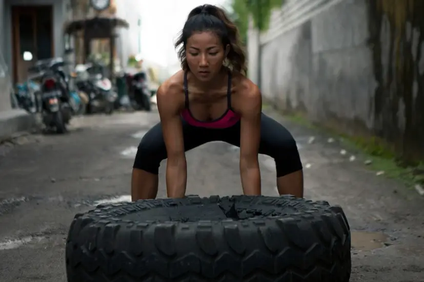 woman lifting a tire