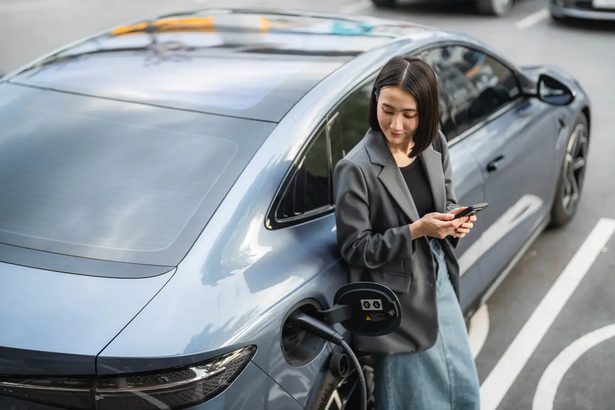 woman-wait-charge-electric-vehicle-singapore