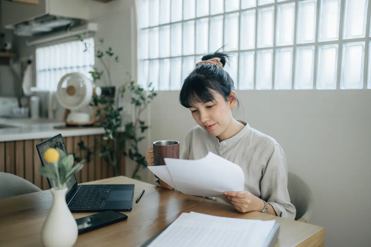 woman looking at her paper 