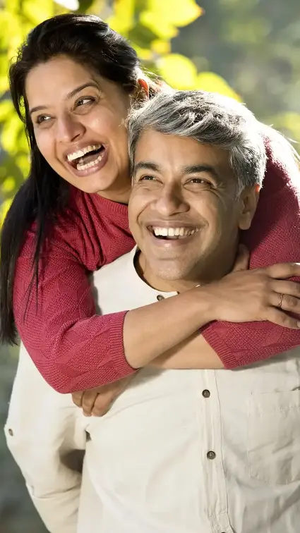 Two people outdoors enjoying a sunny day, symbolizing young seniors planning for retirement, lifestyle protection, and family security.
