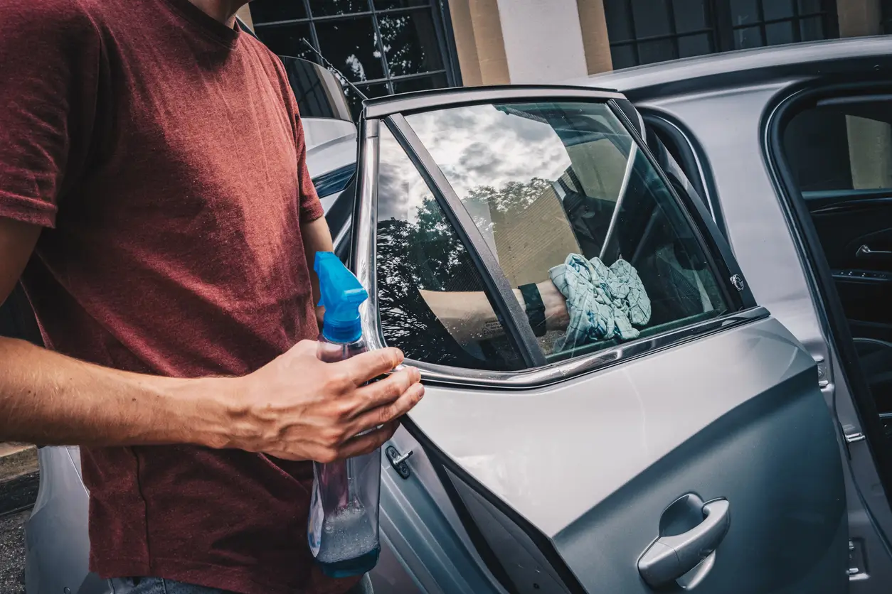 man-wiping-electric-car man-wiping-electric-car
