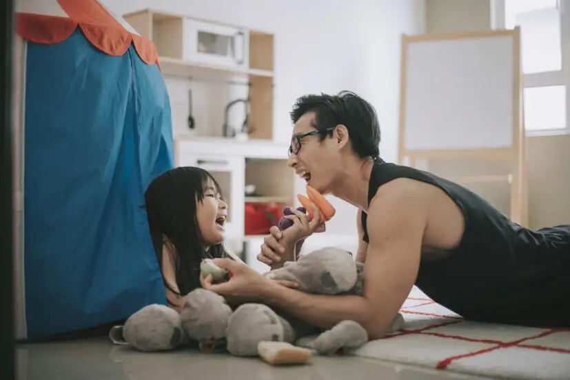 father playing with daughter