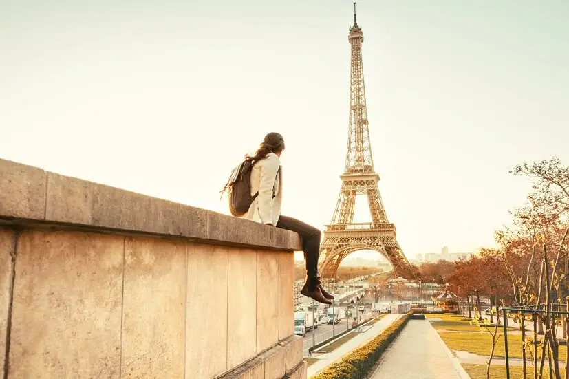 Woman overseas looking at Eiffel Tower​