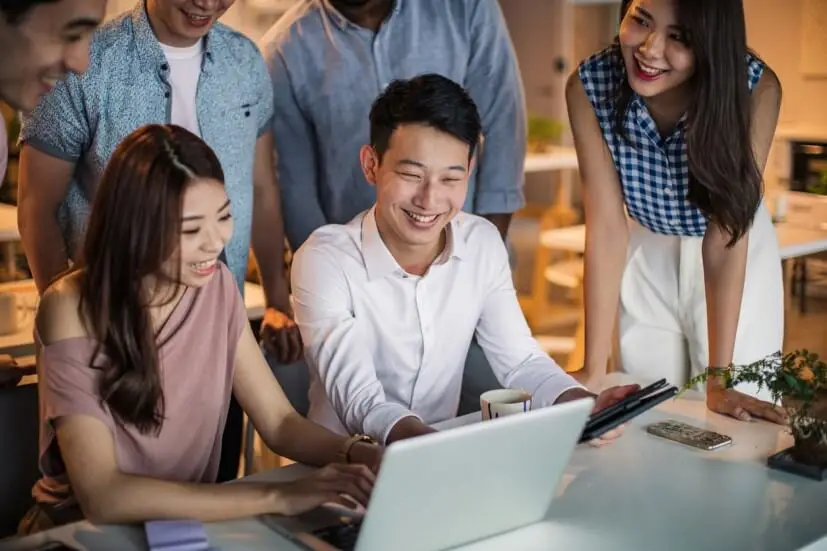 colleagues looking at laptop screen