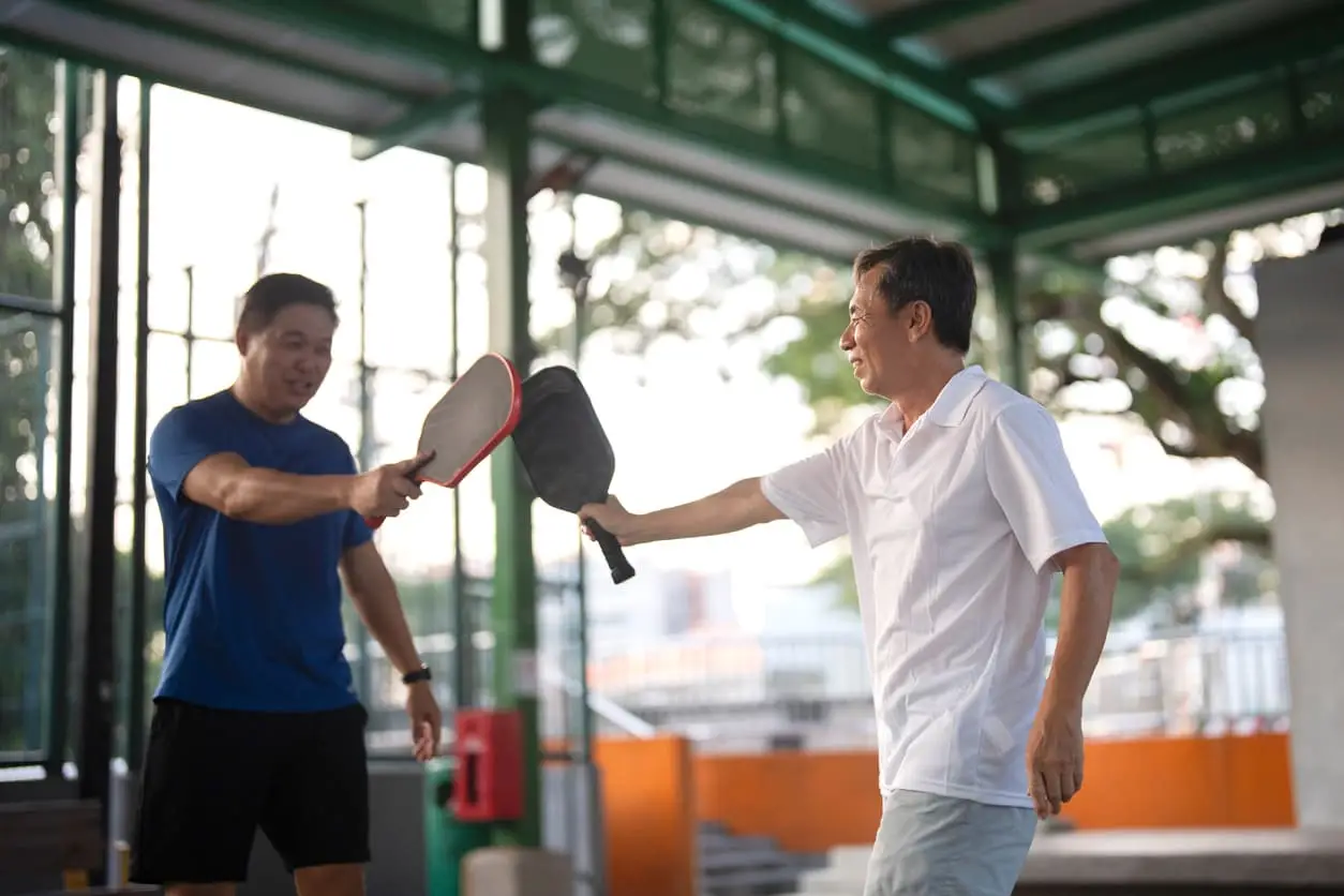 two men playing pickleball
