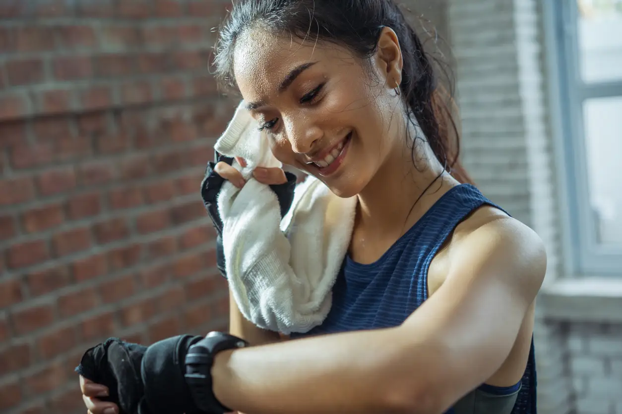 girl wiping perspiration after exercising