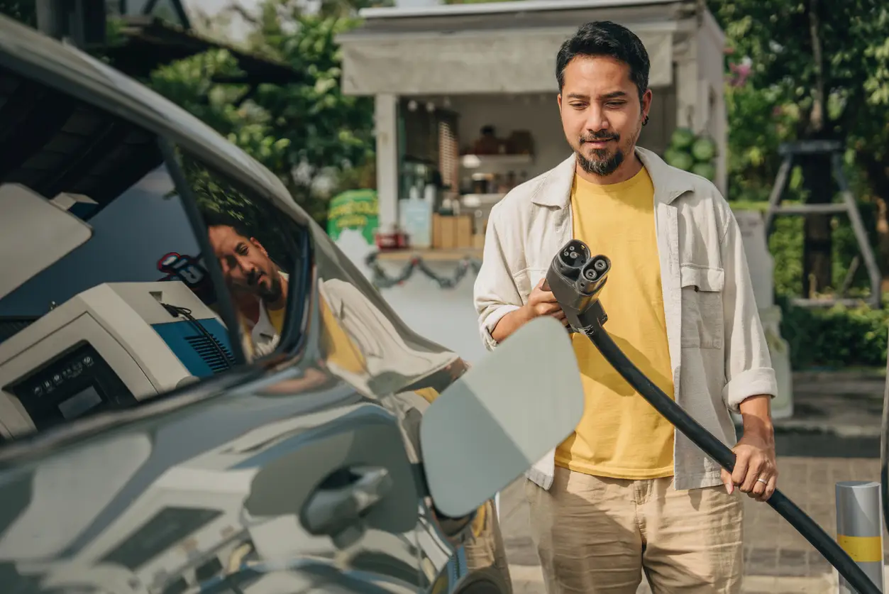 man-charge-electric-vehicle