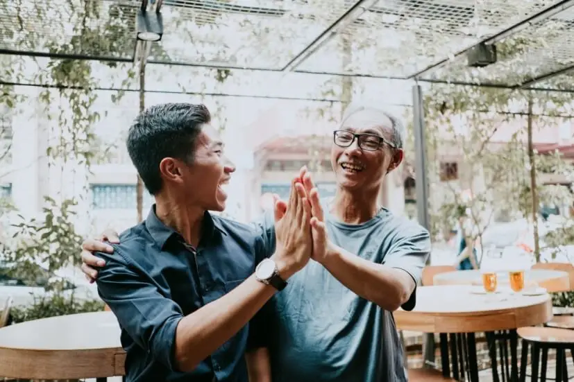 two people clapping hands