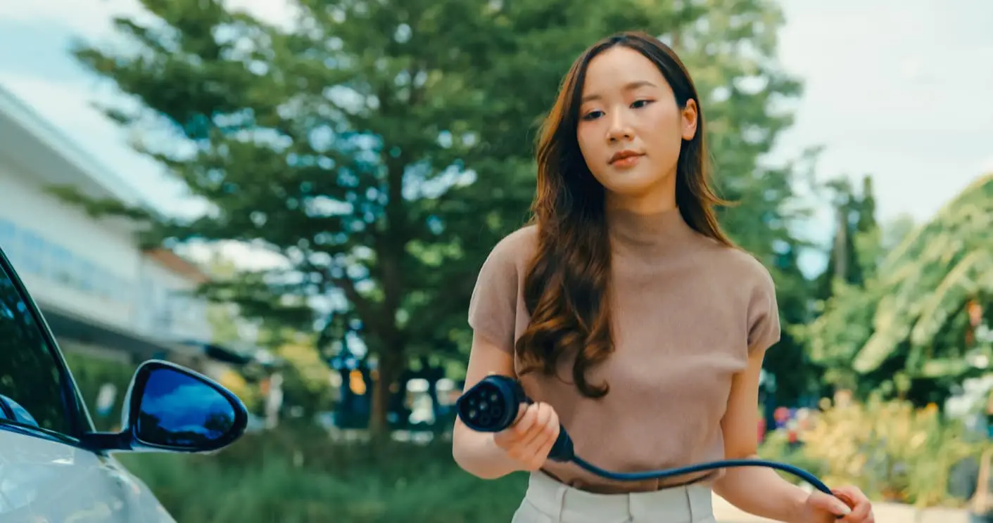 woman charging ev