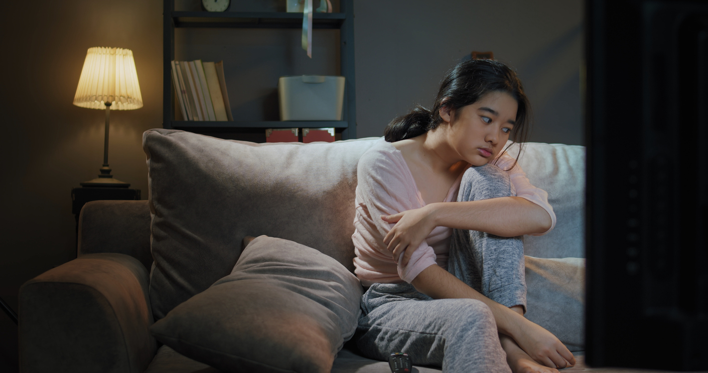 girl sitting on sofa bored