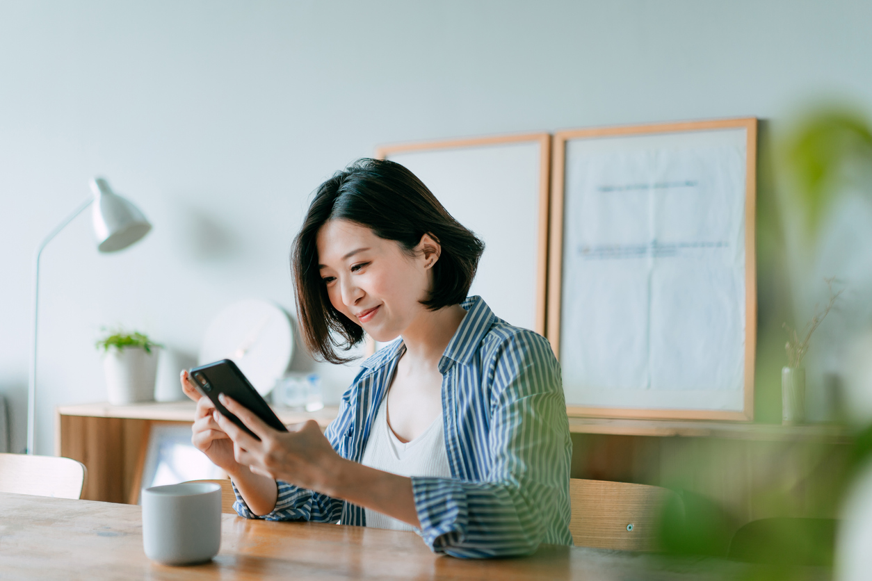 woman looking at phone in home