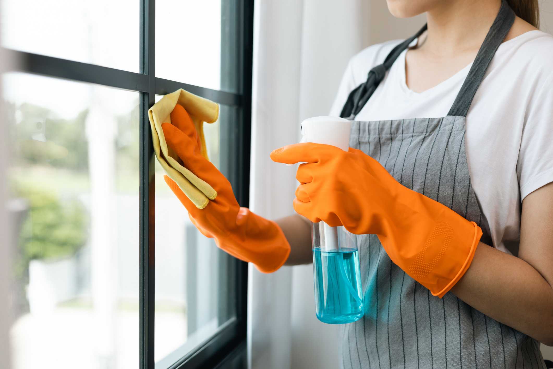 domestic helper wiping window