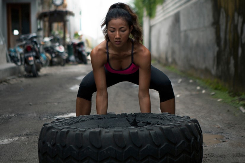 woman lifting a tire