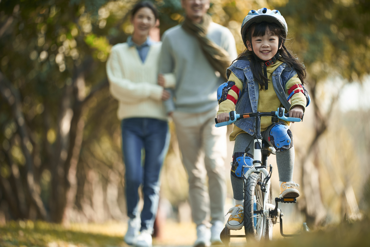 girl riding bike with helmet