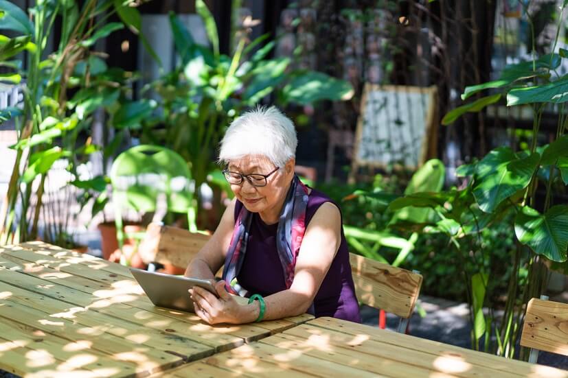 senior looking at tablet