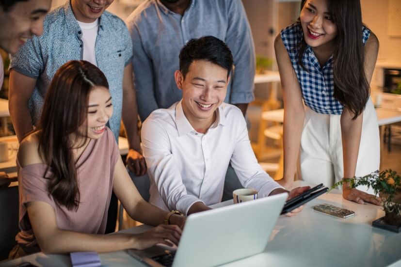 colleagues looking at laptop screen