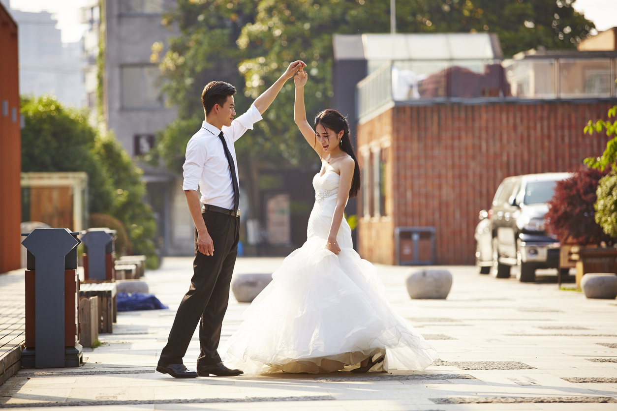 couple in wedding gown on streets
