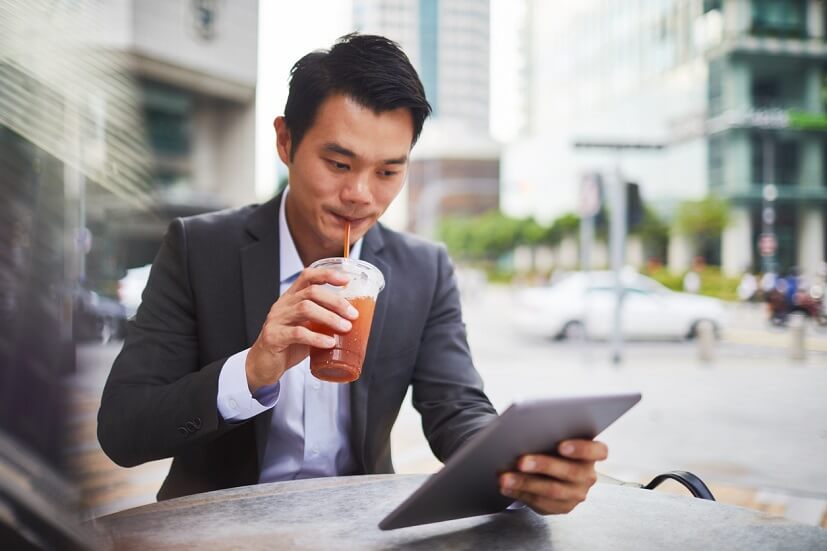 drinking coffee while looking at ipad