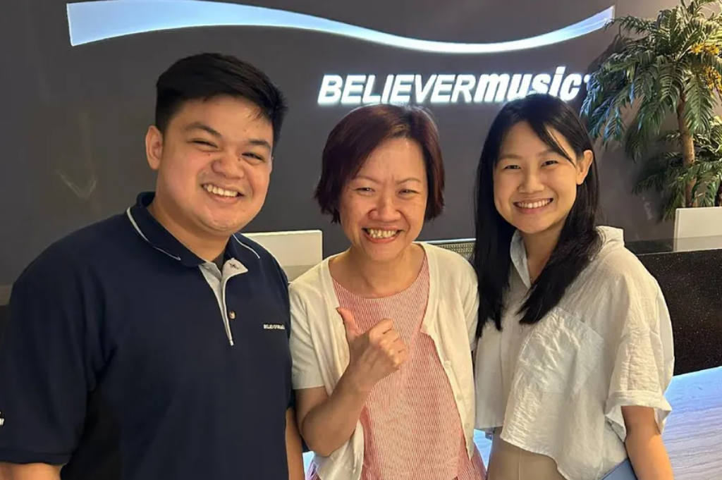 HR Director Nancy Lim (middle) with her colleagues at work. She has added Income's Invest Flex Vantage plan to her portfolio for potential first-year income and premium holiday benefits.